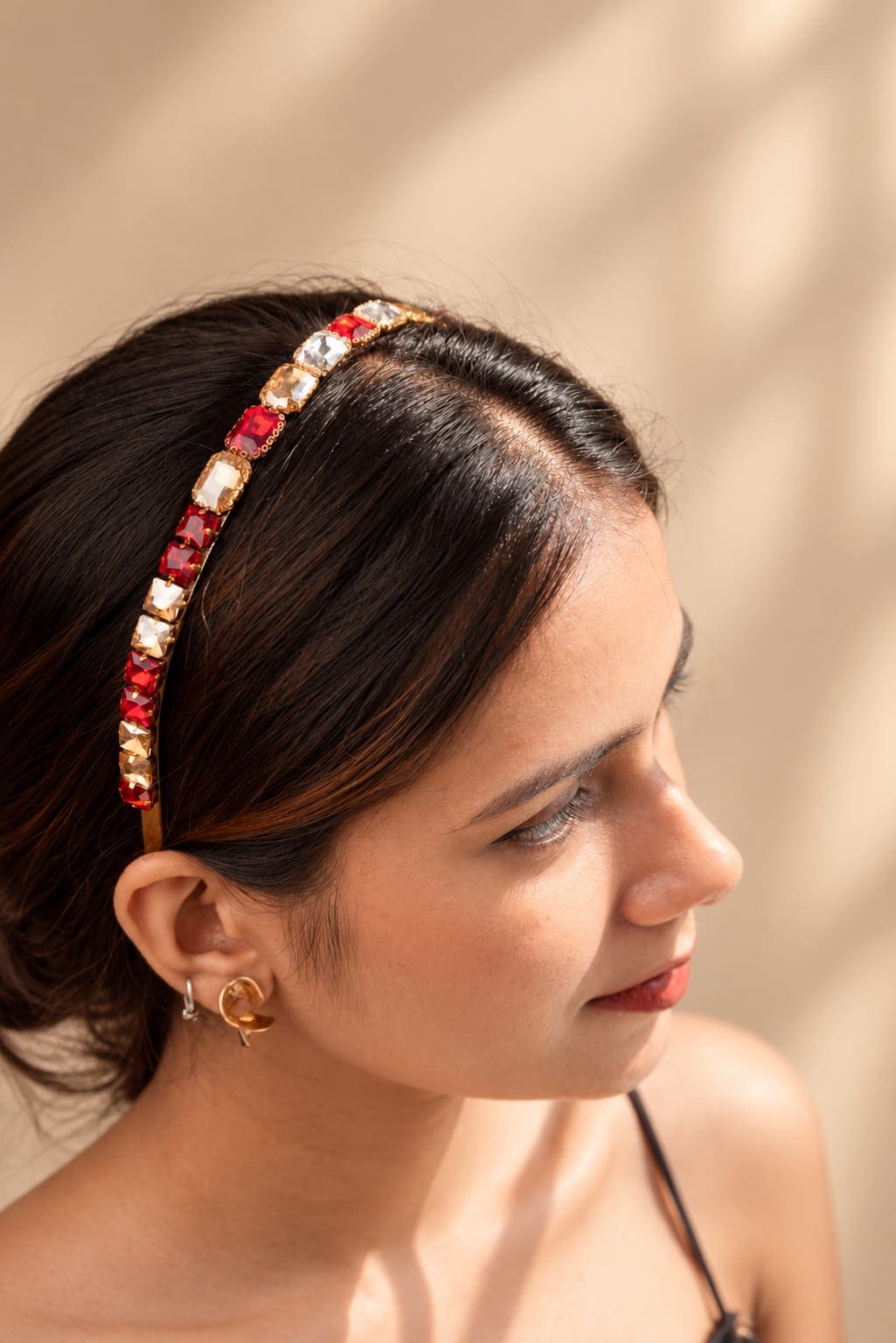 Elegant festive hairband for women featuring alternating rectangular ruby-red and champagne crystals on a thin gold metallic frame.
