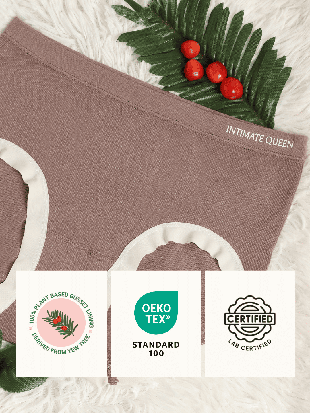 Brown underwear with 'Intimate Queen' branding, green leaf, and yew berries on a textured surface.