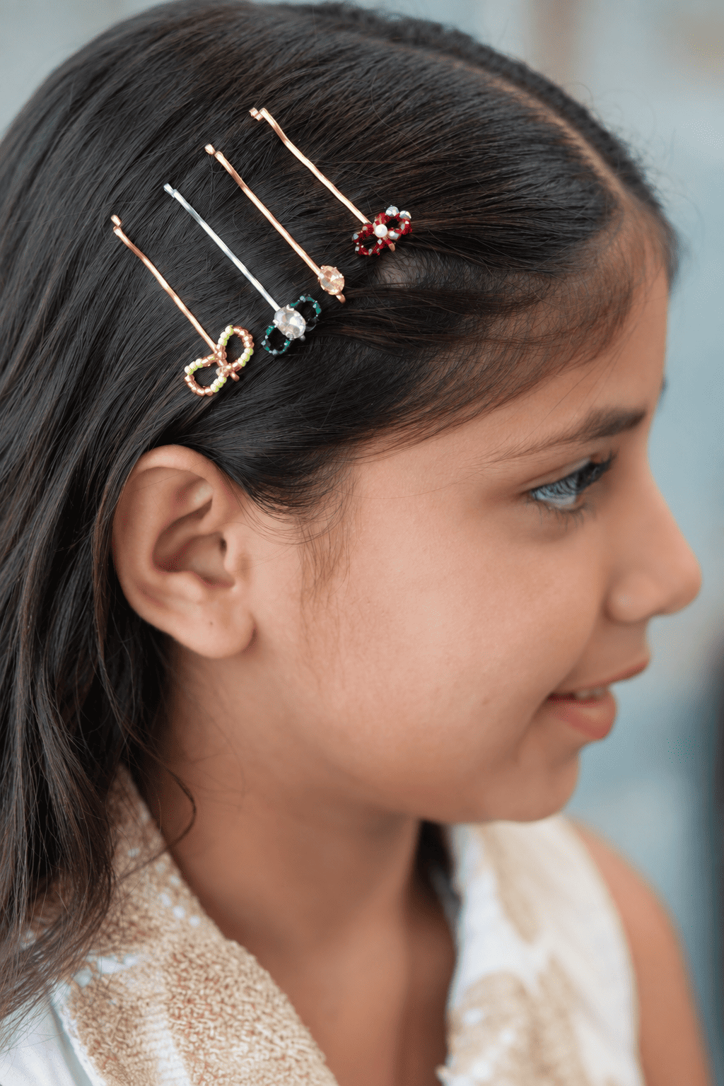 Set of four decorative girls hair pins with floral, bow and crystal details