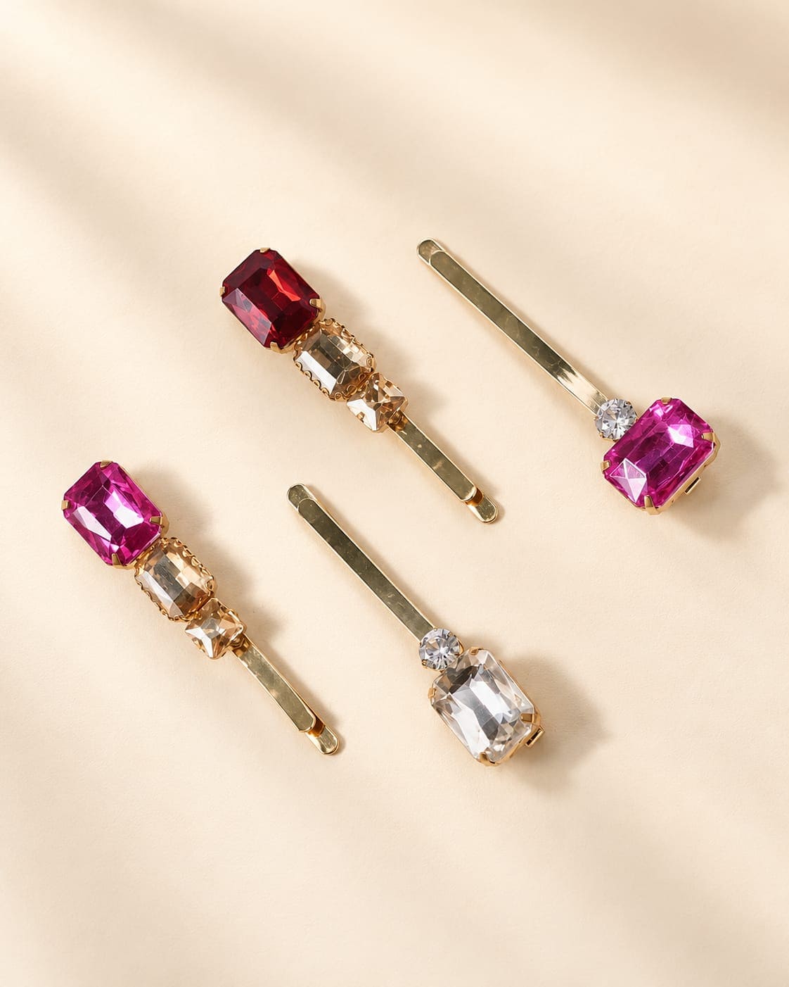 IQ Edit premium set of 4 gold-tone slide hair pins featuring geometric cuts of red, pink, champagne and clear crystal embellishments arranged flat on a neutral background.