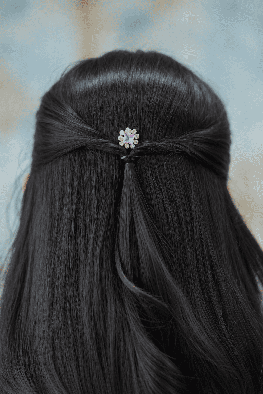 Crystal flower bobby pin styled in a half-up hairstyle