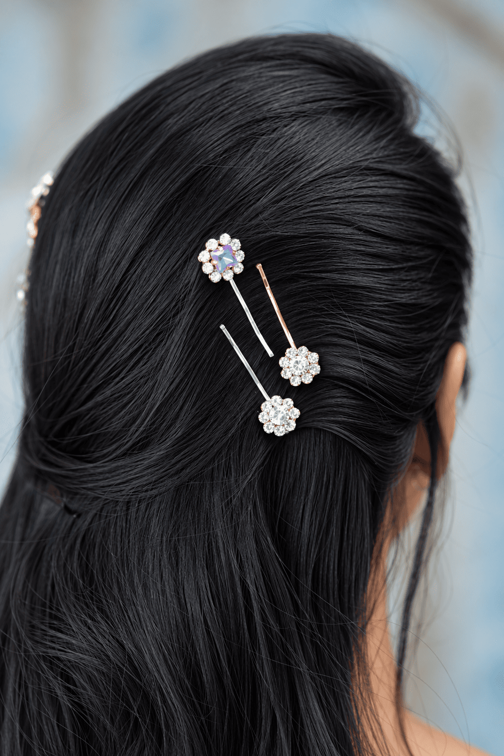 Crystal flower bobby pins with clear and iridescent rhinestones styled in dark hair