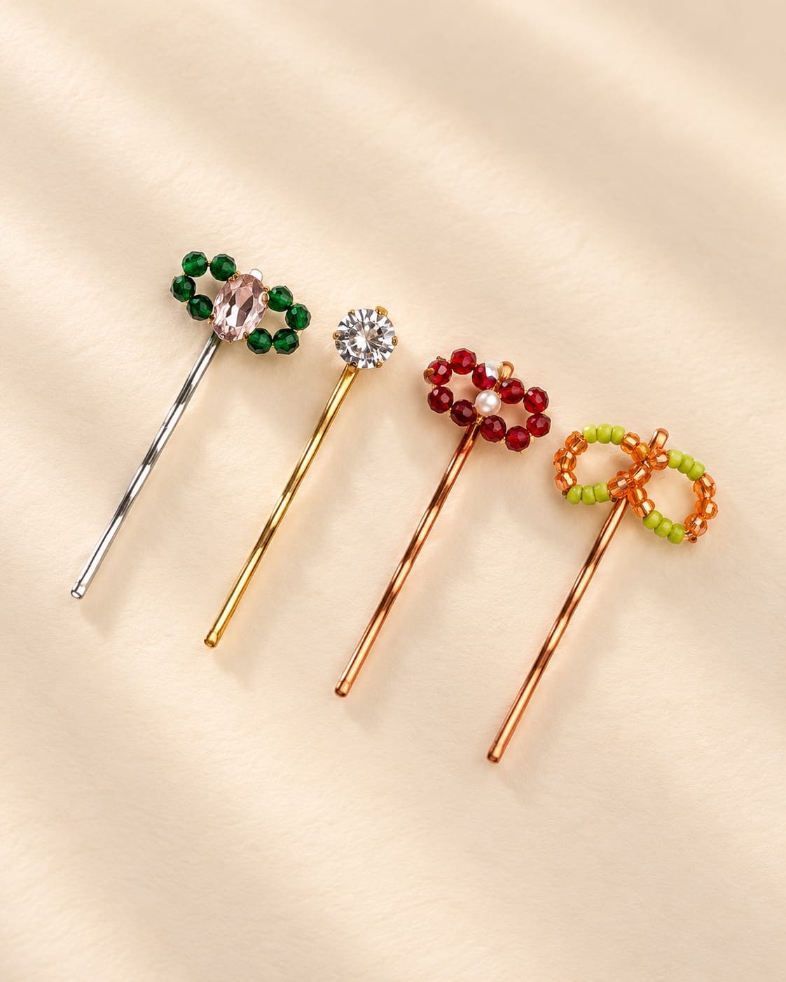 IQ Edit Beaded Bloom Hair Pins 4-pack featuring a silver-tone pin with dark green beads and a pink crystal, alongside three gold-tone pins, deep red beads and olive green-orange beaded bow accents.
