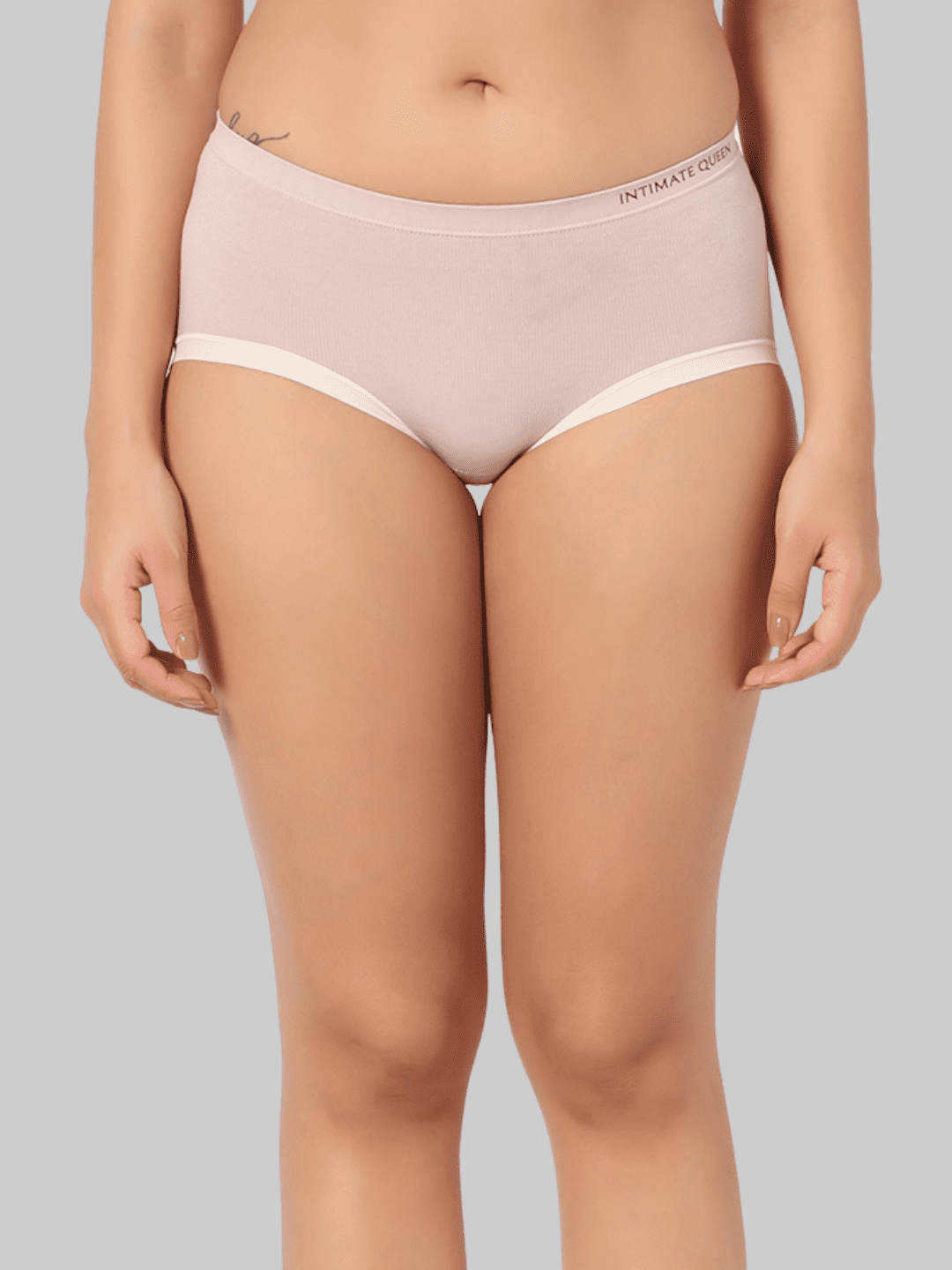 Person wearing pale lavender underwear with a gray background