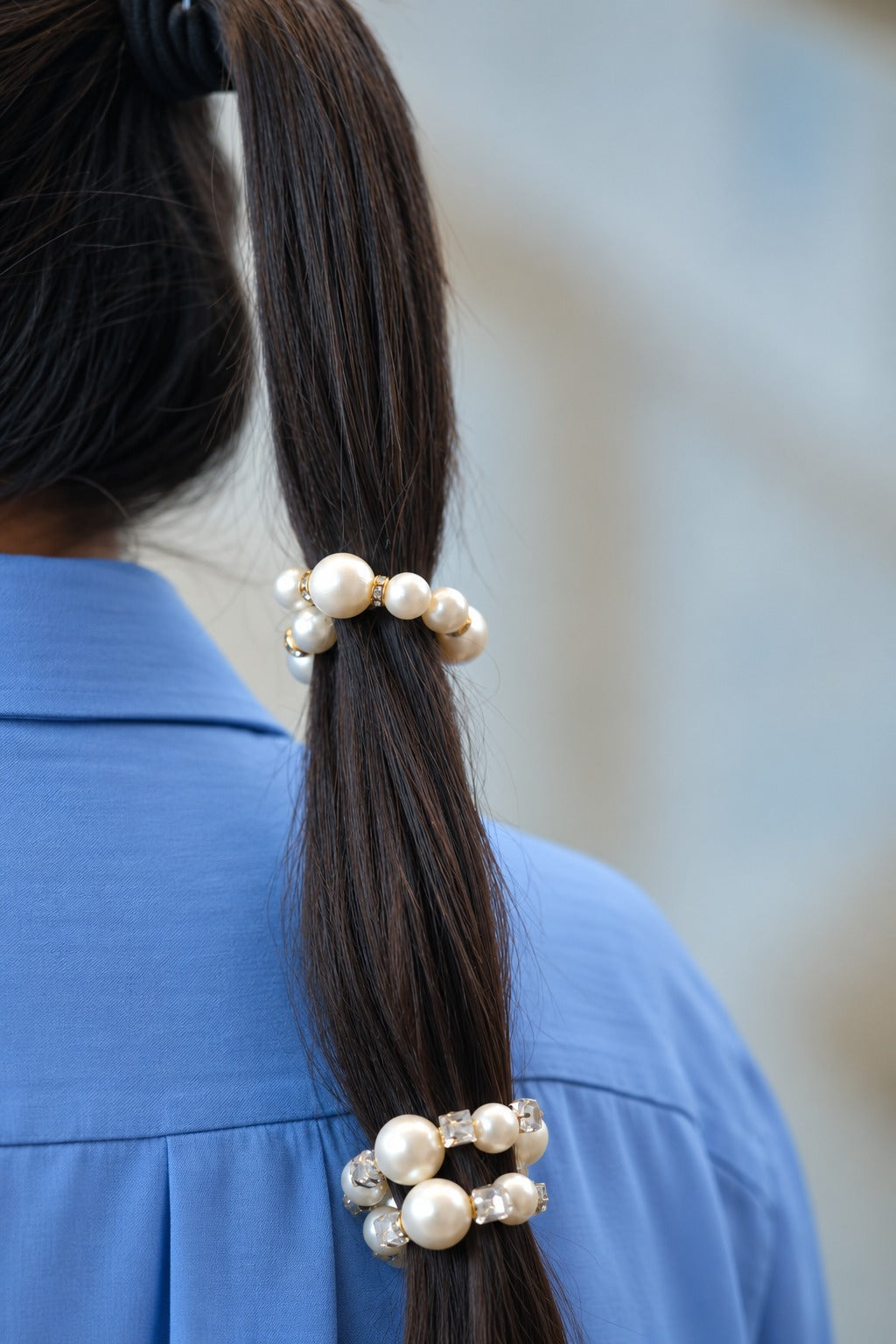Close-up of pearl hair ties styled on a ponytail – silver rhinestone and gold crystal spacer
