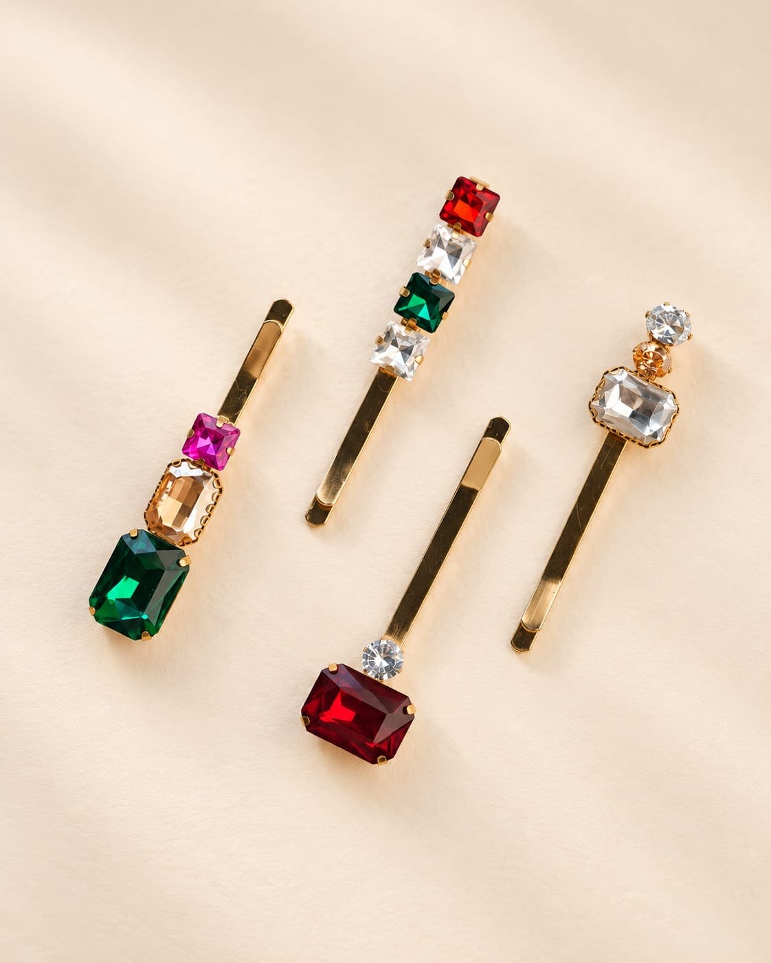 IQ Edit set of 4 gold tone decorative hair pins with emerald green and red crystals on a clean background