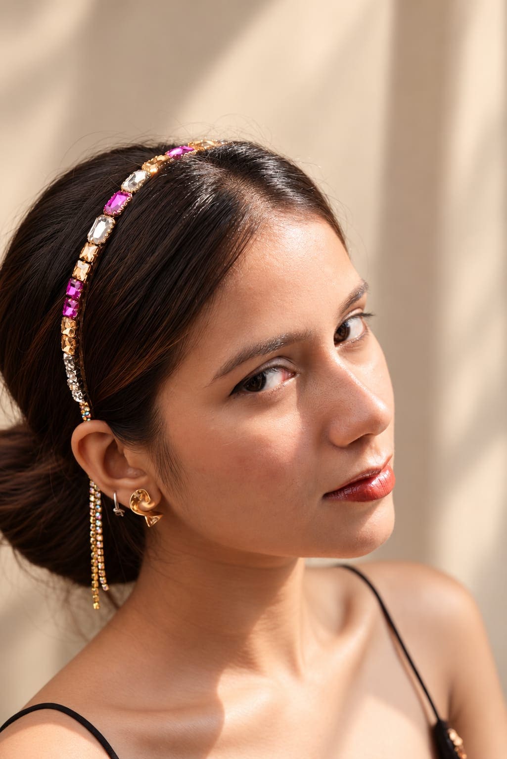 Model wearing the IQ Edit pink rhinestone tassel chain headband with geometric crystals and cascading fringe behind the ear.