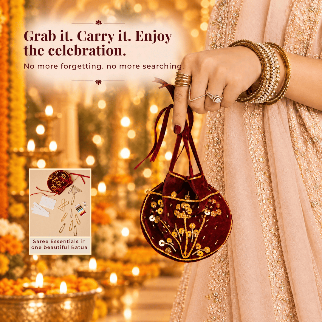 Woman in festive attire carrying a maroon handcrafted velvet Saree Survival Kit batua