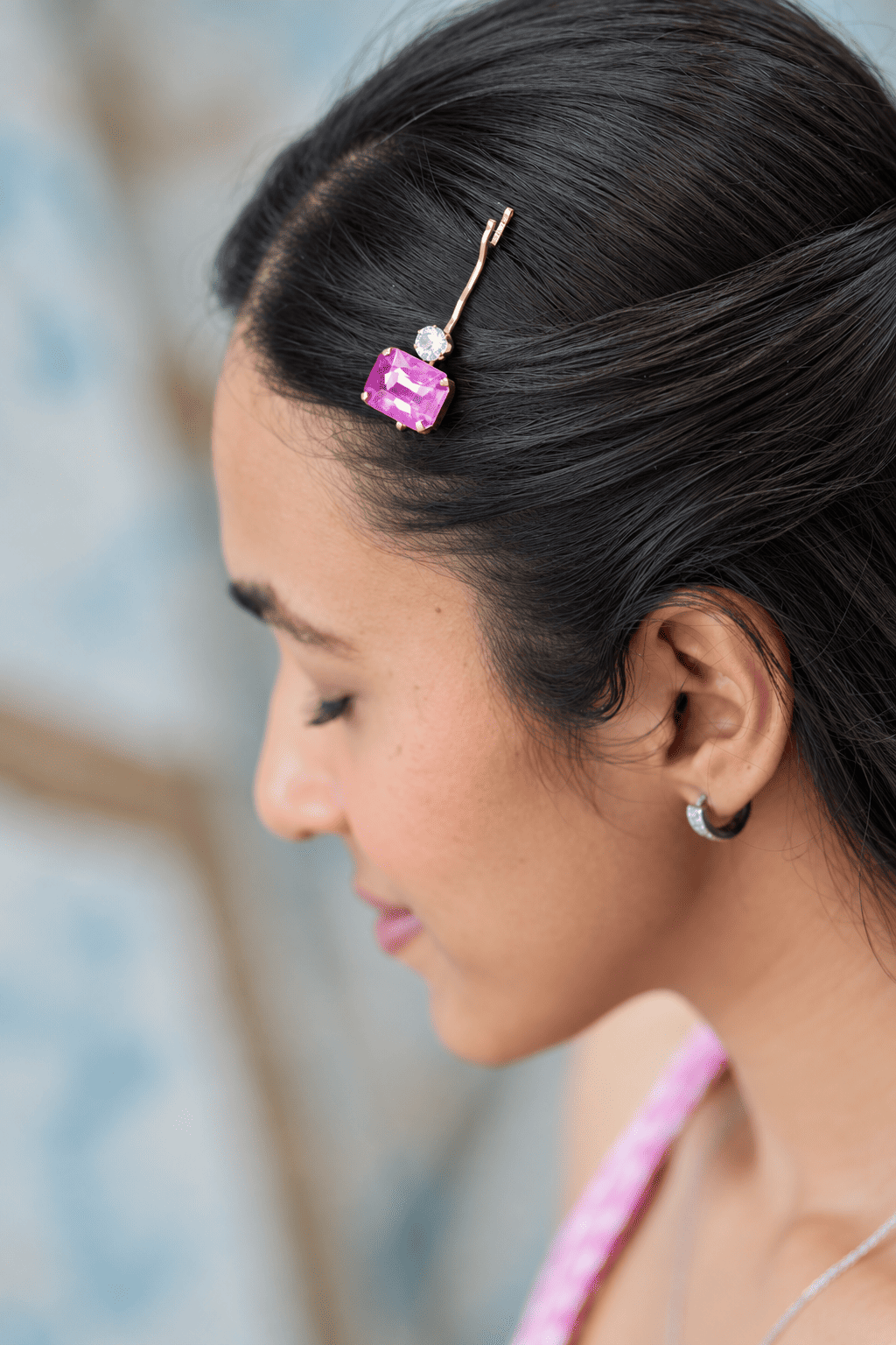 Pink crystal rhinestone bobby pin in black hair