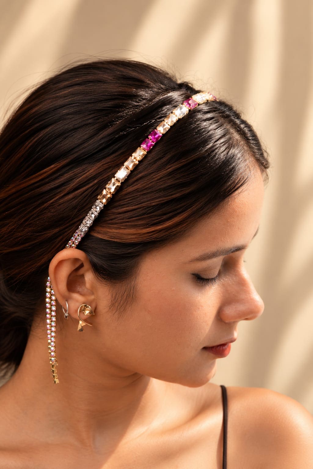 Side profile view of the IQ Edit gemstone hair hoop showing the elegant movement of dangling crystal fringe strands behind the ear.
