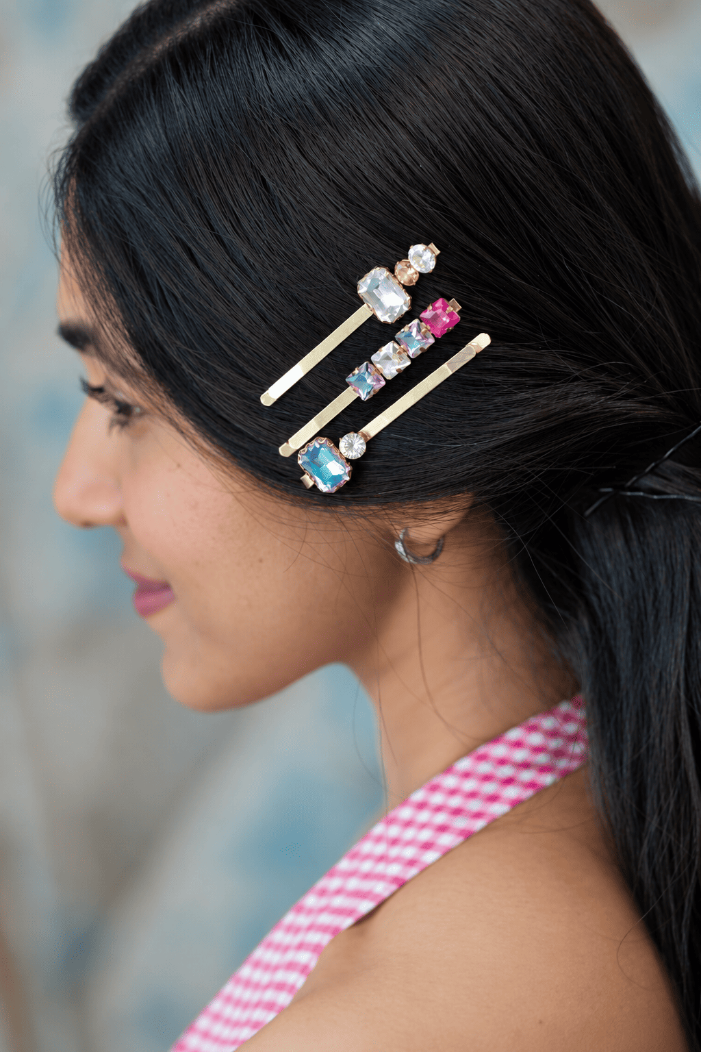 Set of three gold-tone crystal hair pins styled together