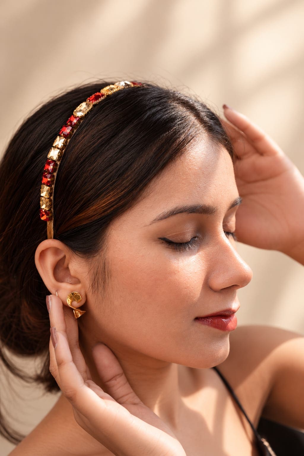 Side profile of a model wearing a luxury red and gold gemstone studded hairband by IQ Edit, showcasing vintage-inspired baroque style hair accessories.