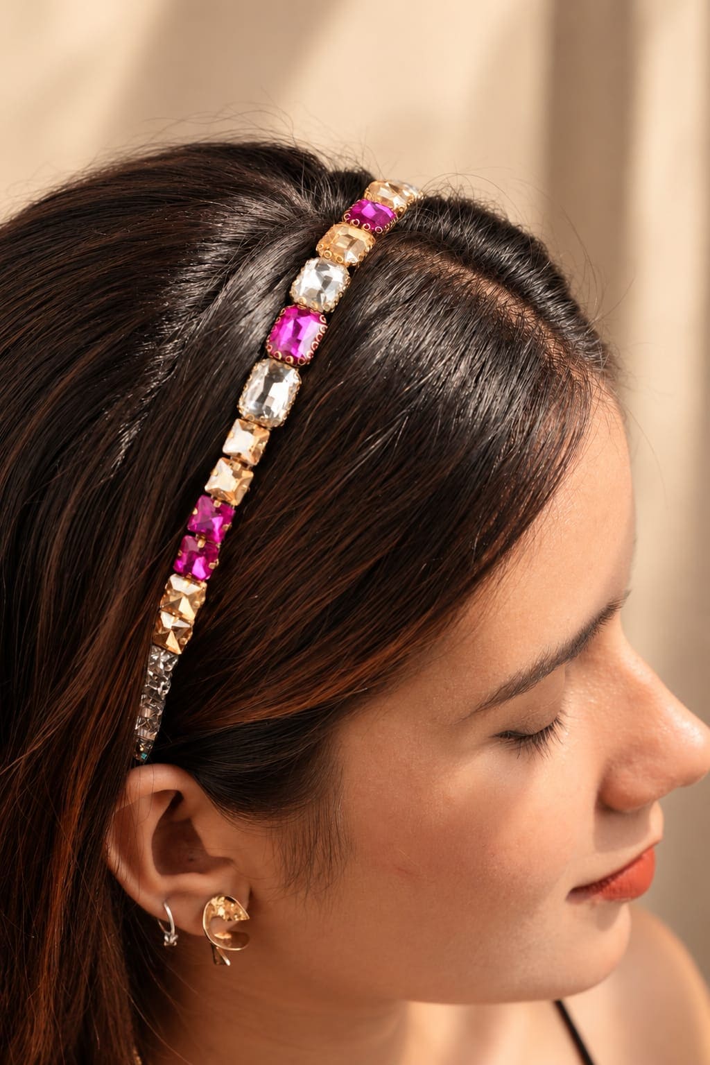 Detailed view from above highlighting the alternating geometric pink tourmaline, clear diamond, and champagne topaz crystals on the IQ Edit luxury headband.