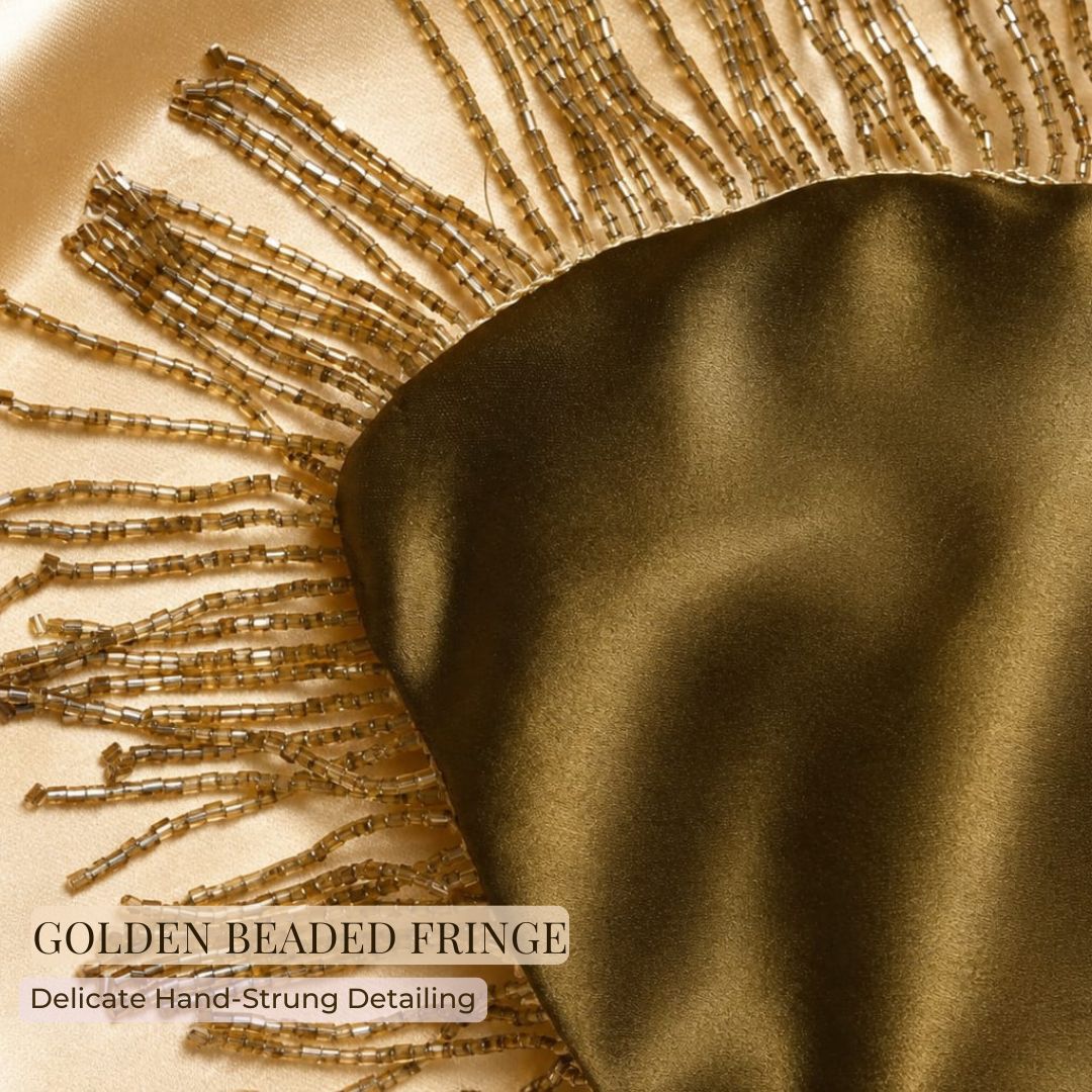 Close-up of gold beaded fringe detailing on an olive green satin gift potli