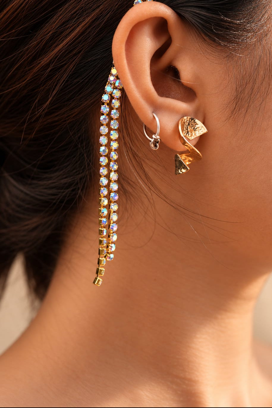 Close-up of iridescent crystal strands hanging from a gold-tone tassel headband