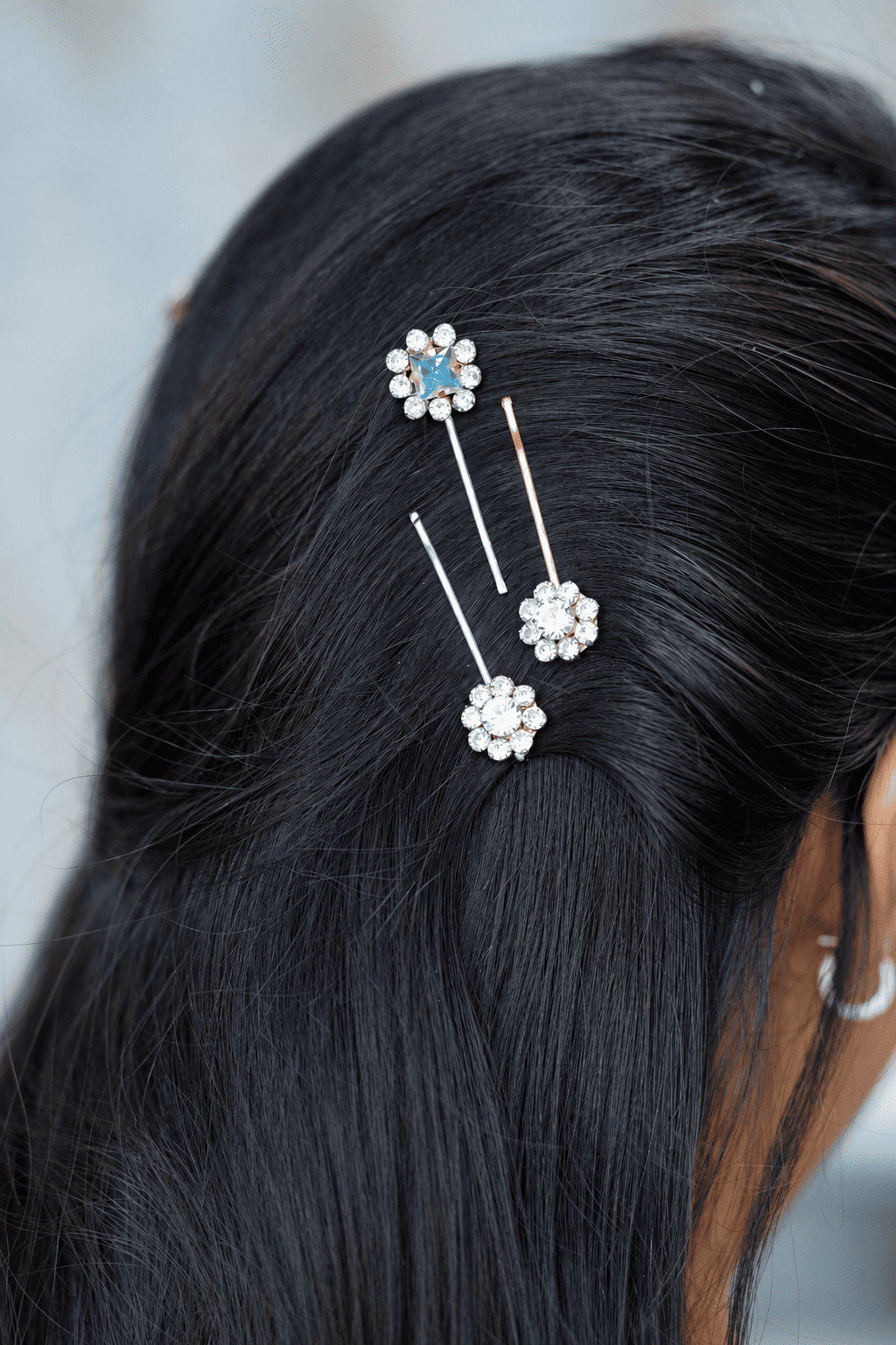 Three crystal flower bobby pins with silver and gold-tone finishes