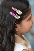 Gold-tone hair clips with hot-pink and champagne rectangular rhinestones